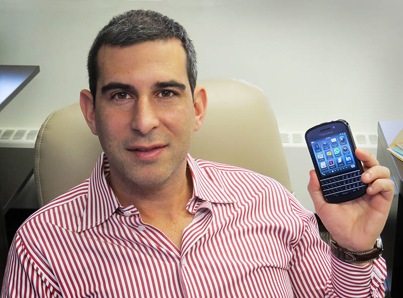 Lawyer Isaac Ziskind holding a BlackBerry Q10