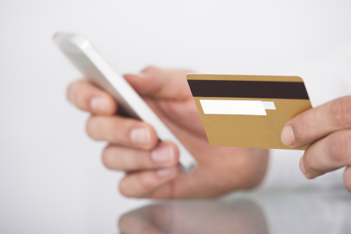 Man Shopping With Credit Card And Mobile Phone