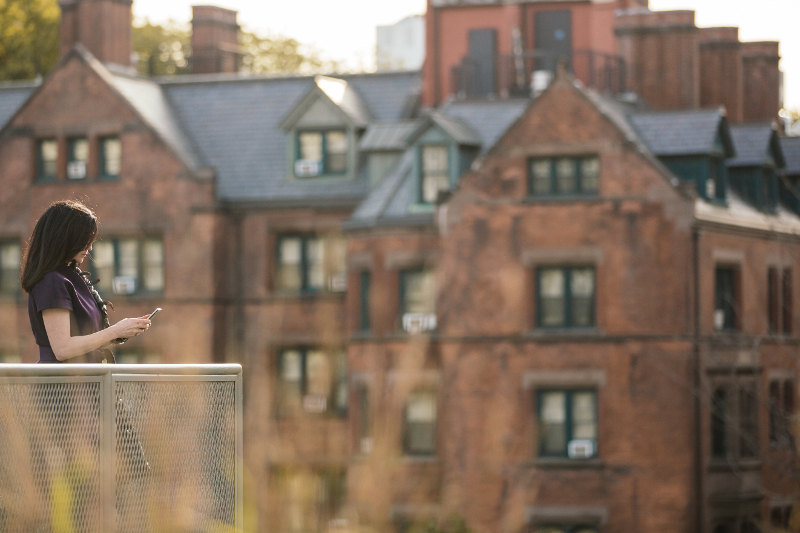 Stacey Jones Looking At Passport on Balcony