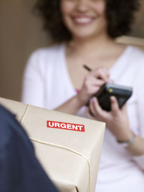 Woman signing for urgent delivery