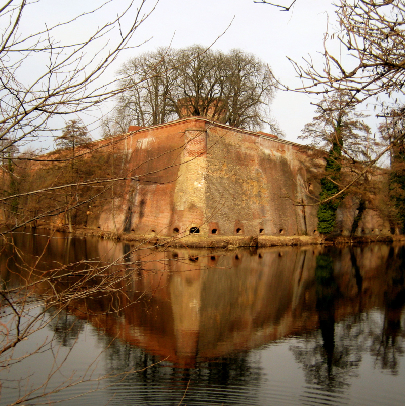 Fortress Wall Reflection In River Against Sky