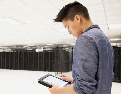 Chinese businessman using tablet computer in server room