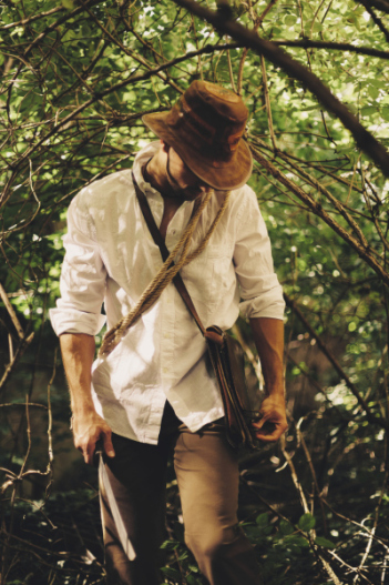 Man walking through forest with machete