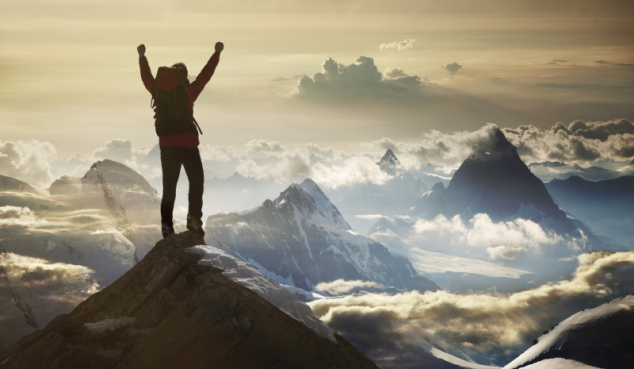 Climber standing on a mountain summit