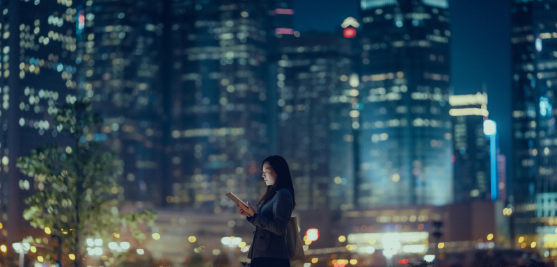 Pretty office lady is using tablet in city