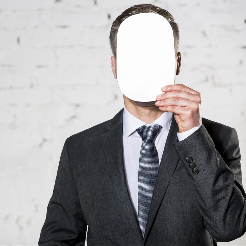 Businessman covering his face