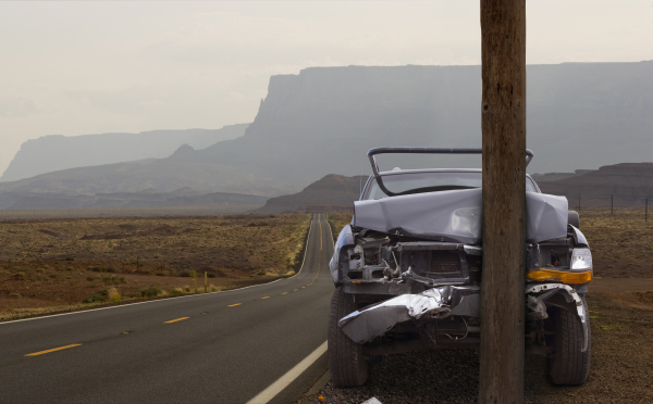 Close up of car crashed into pole on remote road