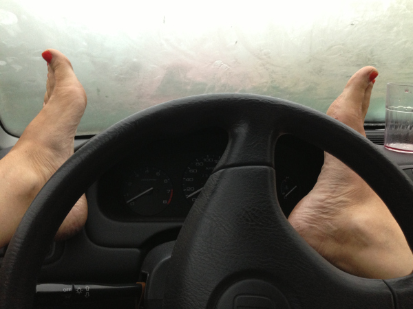 Feet on steering wheel
