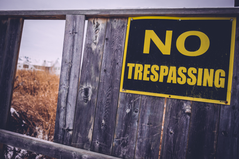 Close-Up Of Sign On Wooden Fence