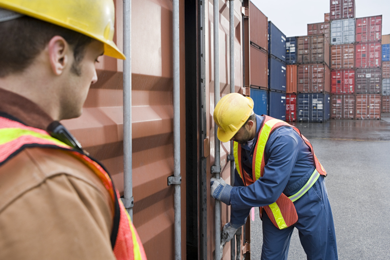 Men working at container terminal