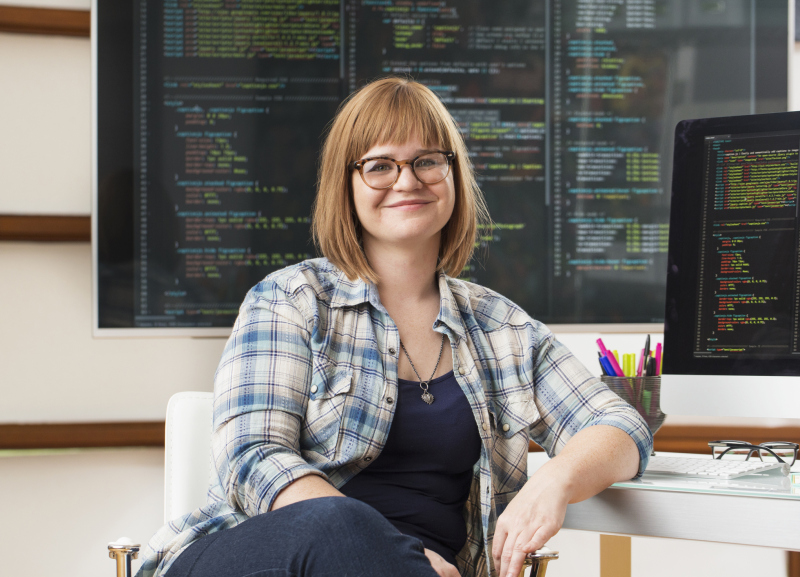 Caucasian businesswoman smiling at computer