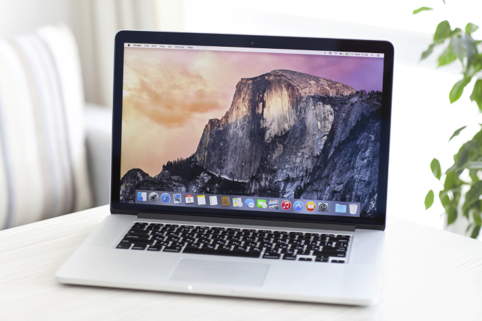 MacBook Pro Retina with OS X Yosemite is on the table in the roo