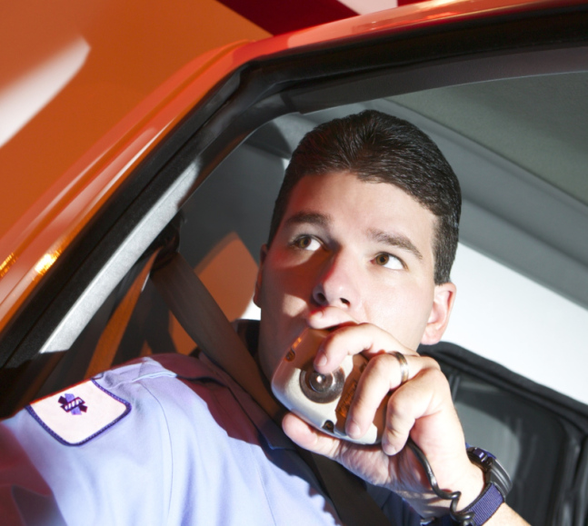 Paramedic using radio in ambulance