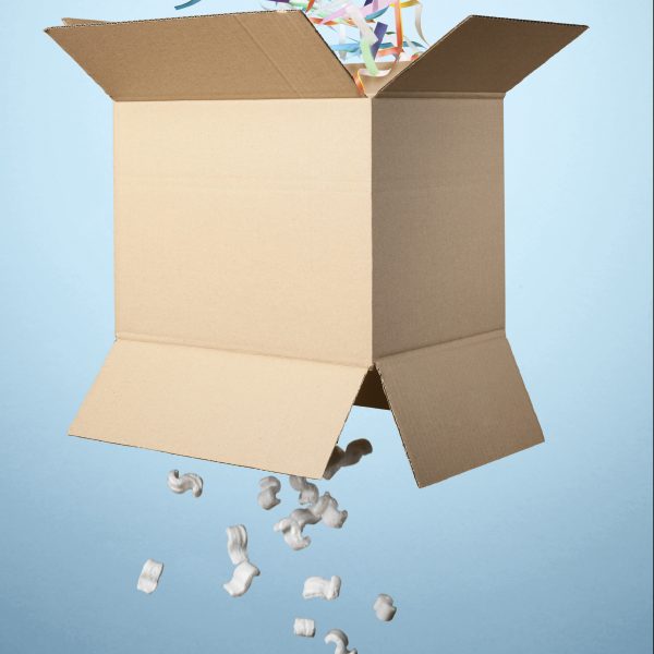 Studio shot of cardboard box with streamers exploding out