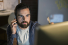 Serious businessman working late at computer in office