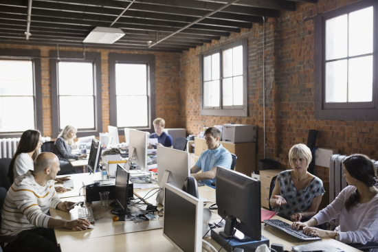 Business people working at computer workstations in office