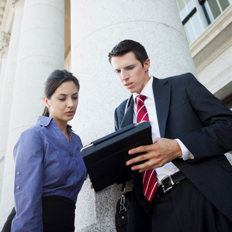 government workers looking at mobile tablet